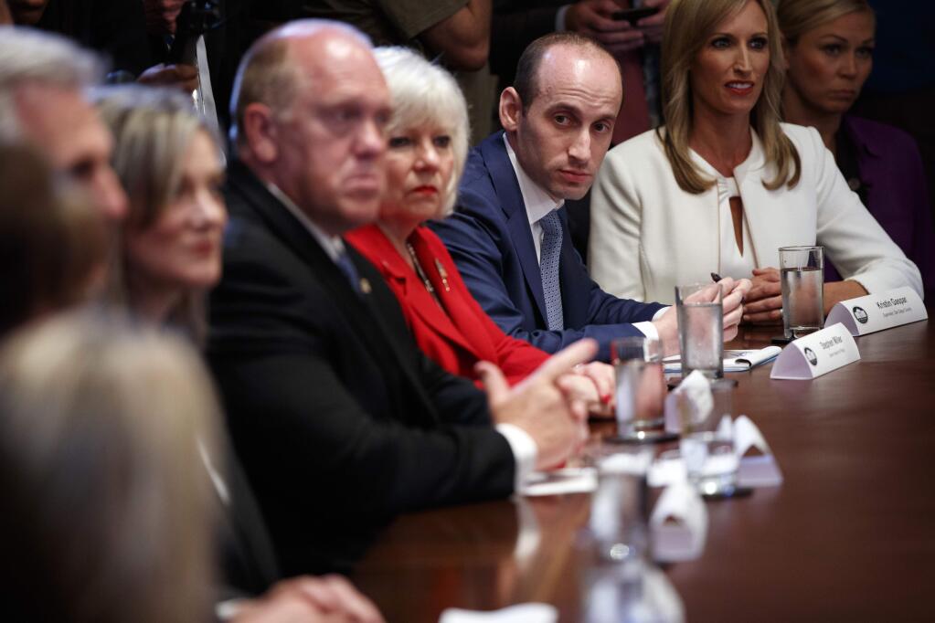 White House senior adviser Stephen Miller listens to President Donald Trump speak during a roundtable on immigration policy in California, in the Cabinet Room of the White House, Wednesday, May 16, 2018, in Washington. (AP Photo/Evan Vucci)
