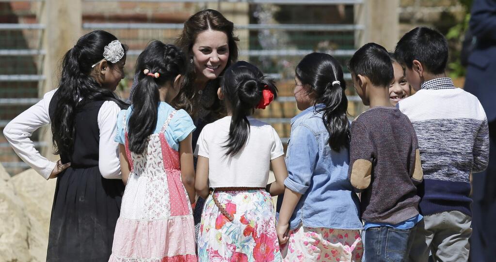 Britain's Kate, Duchess of Cambridge smiles as she meets children during a tour and official opening of the new Magic Garden at Hampton Court Palace in London, Wednesday May 4, 2016. (AP Photo/Tim Ireland)