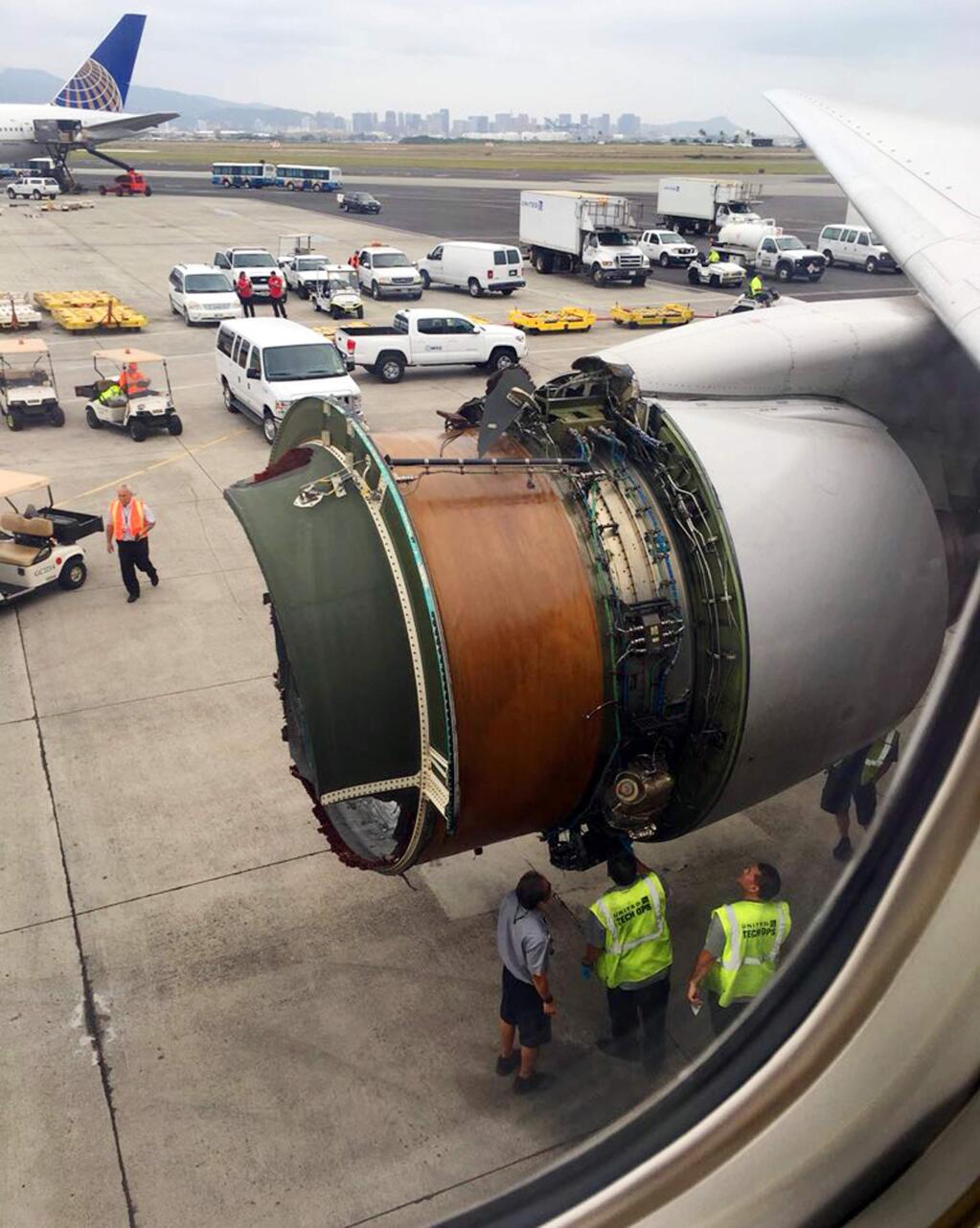 This photo provided by passenger Haley Ebert shows damage to an engine on what the FAA says is a Boeing 777 after parts came off the jetliner during its flight from San Francisco to Honolulu Tuesday, Feb. 13, 2018. The plane landed safely as emergency responders waited nearby. United Airlines spokeswoman Natalie Noonan says Flight 1175 made an emergency landing due to a mechanical issue. (Haley Ebert via AP)