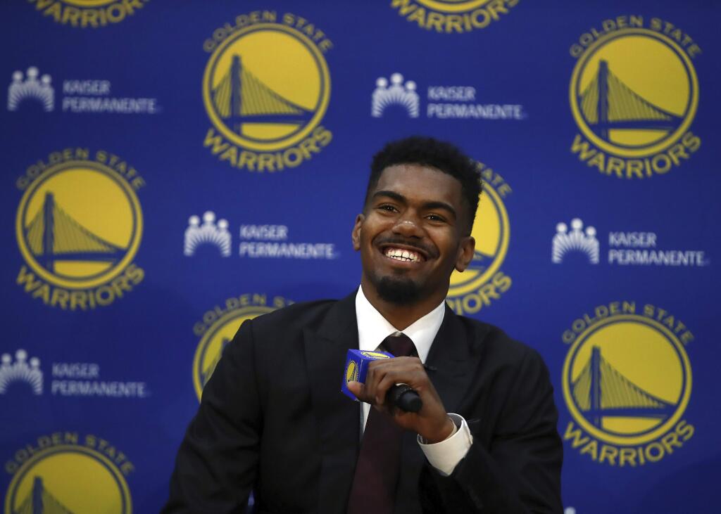 Golden State Warriors NBA basketball team draft pick, Jacob Evans, smiles during a media conference Monday, June 25, 2018, in Oakland, Calif. (AP Photo/Ben Margot)