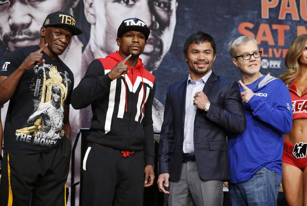 Floyd Mayweather Sr., from left, Floyd Mayweather Jr., Manny Pacquiao and Freddie Roach pose for photographers during a news conference Wednesday, April 29, 2015, in Las Vegas. Mayweather Jr. will face Pacquiao in a welterweight boxing match in Las Vegas on May 2. (AP Photo/John Locher)