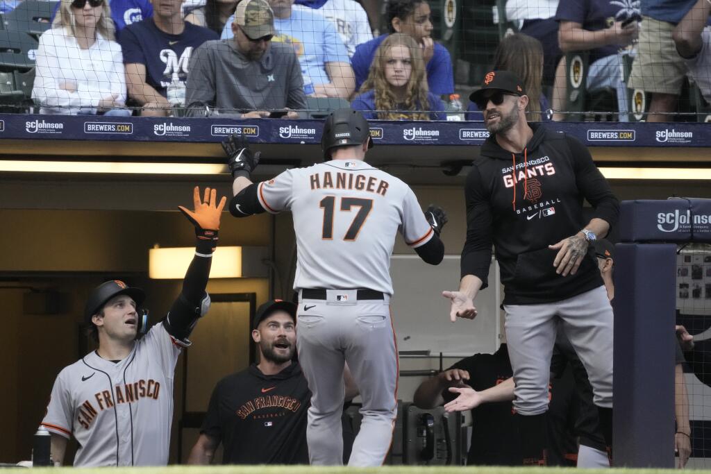 The Giants’ Mitch Haniger is congratulated after hitting a two-run home run during the eighth inning Saturday against the Brewers in Milwaukee. (Morry Gash / ASSOCIATED PRESS)