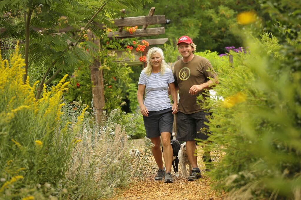 Kate and Ben Frey walk through their home garden in Hopland on Wednesday, July 16, 2014. The Frey's gardens have gained international acclaim after they garnered gold medals at the famed Chelsea Flower Show in London. (Conner Jay/The Press Democrat)