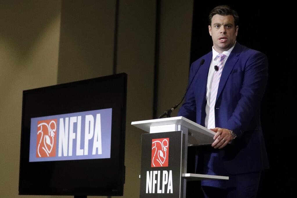FILE - In a Thursday, Jan. 30, 2020 file photo, Eric Winston, president of the NFL Players Association, speaks at the annual state of the NFLPA press conference, in Miami Beach, Fla. NFL players have approved a new labor agreement with the league that features a 17-game regular season, higher salaries, increased roster sizes and larger pensions for current and former players. (AP Photo/Chris Carlson, File)