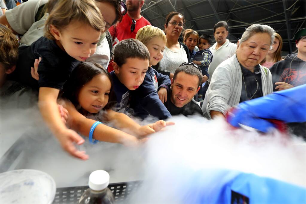 Children and parents feels the cold of liquid nitrogen used to make quick ice cream in an experiment sponsored by the Buck Institute at the fifth annual North Bay Science Discovery Day at the Sonoma County Fairgrounds on Saturday. (JOHN BURGESS / The Press Democrat)