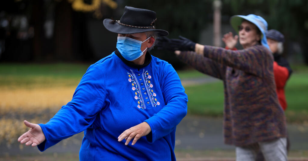 From left, Meganwind Eoyang, Linda Park and Liz Caulkin perform tai chi at Juilliard Park, Wednesday, Dec. 8, 2021 in Santa Rosa as they get their daily exercise. The women meet, often with a larger group, several times a week at the park. (Kent Porter / The Press Democrat) 2021