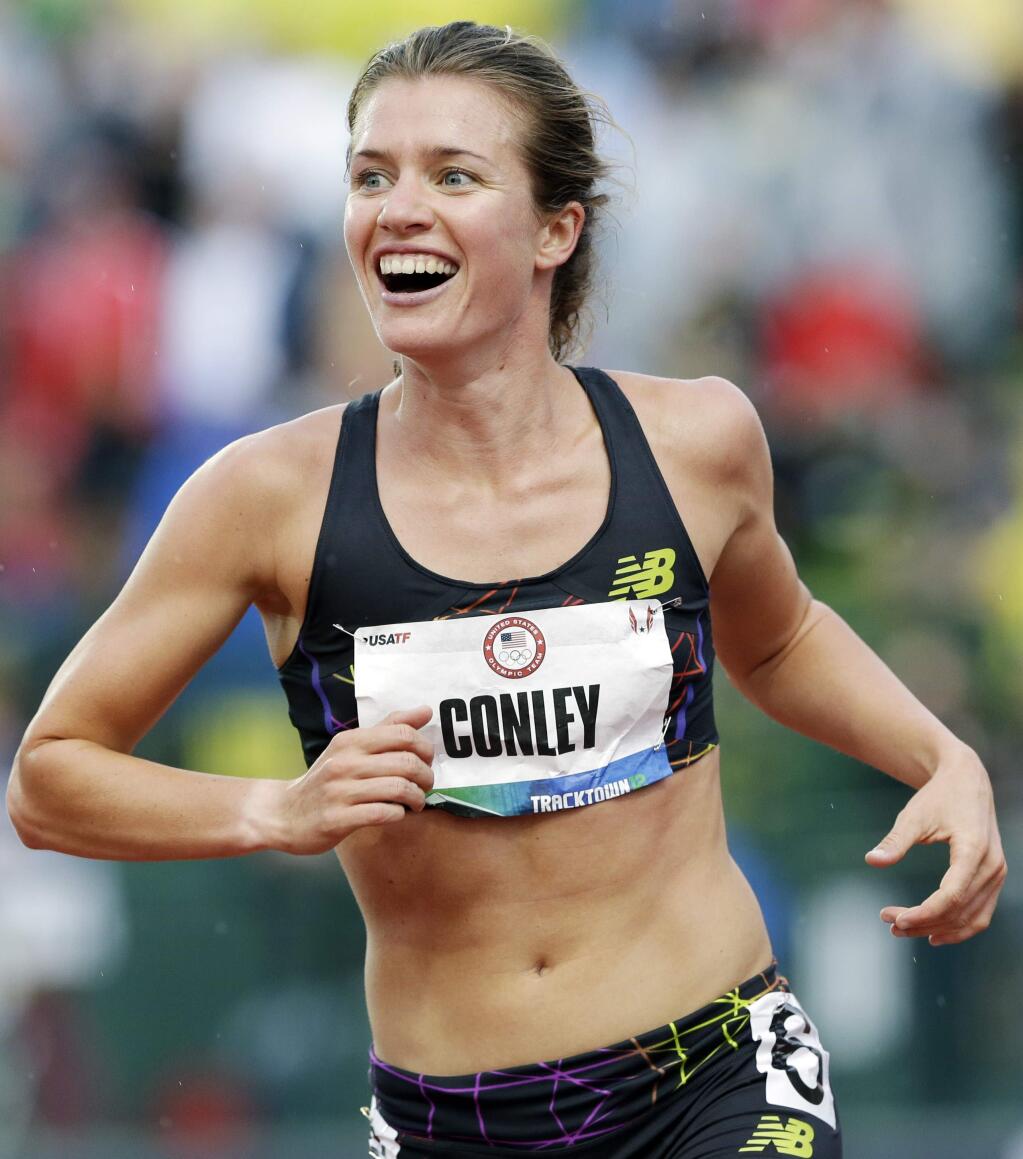 Kim Conley reacts after seeing that her last-second push against Julia Lucas won the third and final spot on the Olympic team in the women's 5,000 meters at the U.S. Olympic Track and Field Trials Thursday, June 28, 2012, in Eugene, Ore. (AP Photo/Eric Gay)