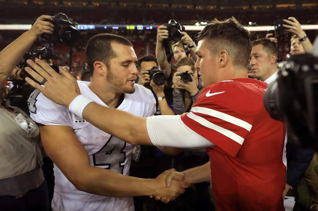San Francisco quarterback Nick Mullens, right is congratulated by Raiders quarterback Derek Carr after Mullens and the rest of the 49ers beat Oakland 34-3 Thursday Nov. 1, 2018 in Santa Clara. (Kent Porter / The Press Democrat)