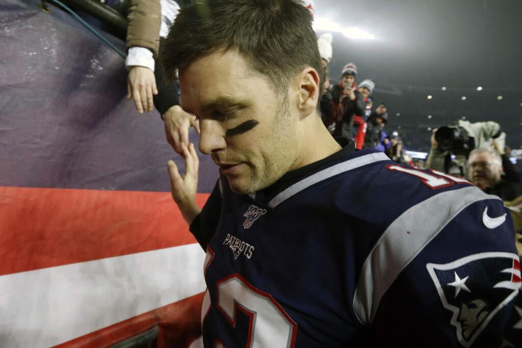 FILE - In this Jan. 4, 2020, file photo, New England Patriots quarterback Tom Brady shakes hands with a fan as he leaves the field after losing an NFL wild-card playoff football game to the Tennessee Titans in Foxborough, Mass. Tom Brady is an NFL free agent for the first time in his career. The 42-year-old quarterback with six Super Bowl rings said Tuesday morning, March 17, 2020, that he is leaving the New England Patriots. (AP Photo/Bill Sikes, File)