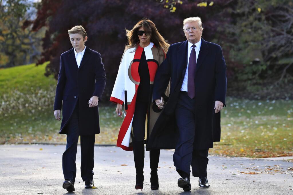 President Donald Trump with first lady Melania Trump and their son Barron Trump walk from the Oval Office as they leave the White House in Washington, Tuesday, Nov. 20, 2018, to travel to Florida, where they will spend Thanksgiving at Mar-a-Lago. (AP Photo/Manuel Balce Ceneta)