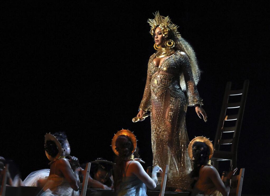 FILE - This Feb. 12, 2017 file photo shows Beyonce performing at the 59th annual Grammy Awards in Los Angeles. Beyonce, who is pregnant with twins, will not perform at Coachella this year, but will headline the festival in 2018. In a joint statement released Thursday, Feb. 23, Beyonce's Parkwood Entertainment and festival producer Goldenvoice said the pop star had to pull out of the famed festival under doctor's orders. (Photo by Matt Sayles/Invision/AP, File)