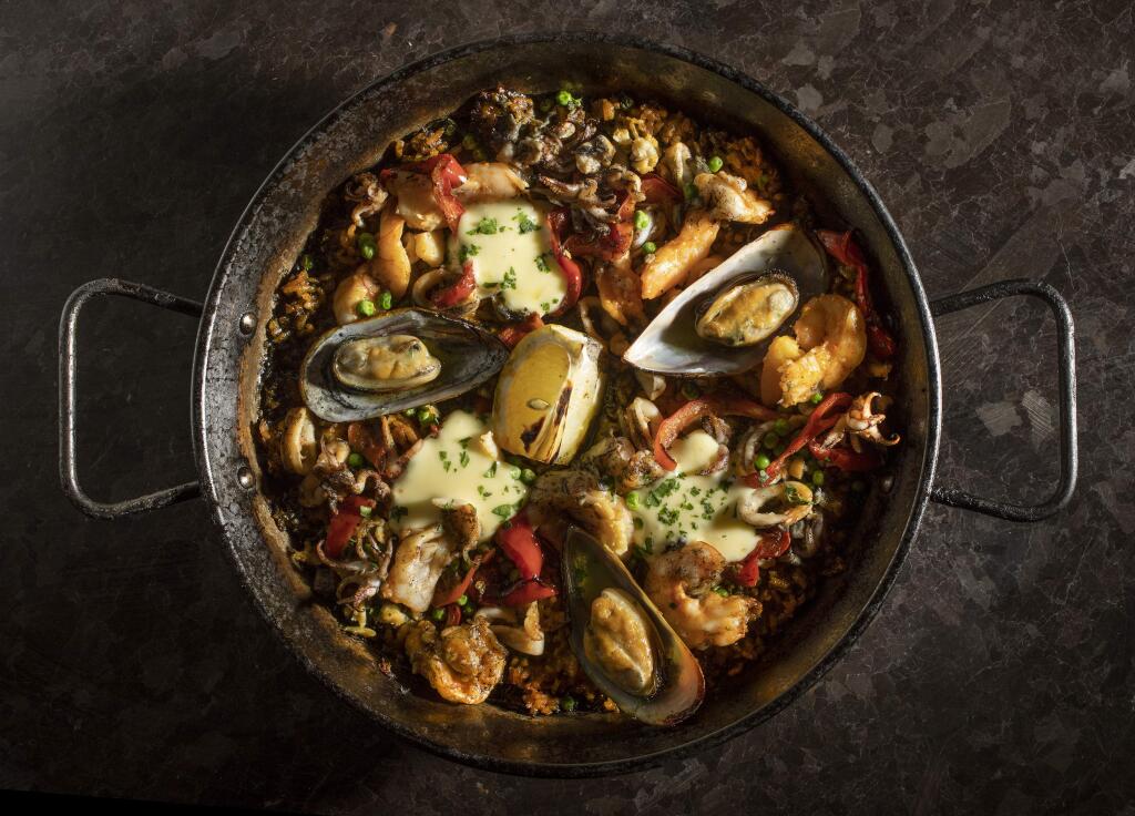 El Pescador Paella with sea clams, mussels, prawns, squid, sweet peas, arroz negro, peppers and aioli from Gerard's Paella Y Tapas in downtown Santa Rosa. (photo by John Burgess/The Press Democrat)