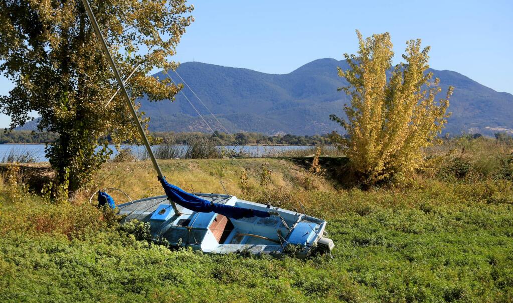 In Lakeport's dry Esplanade on Clear Lake, a sailboat is supported by hydrilla, Tuesday Oct. 20, 2015. (Kent Porter / Press Democrat) 2015
