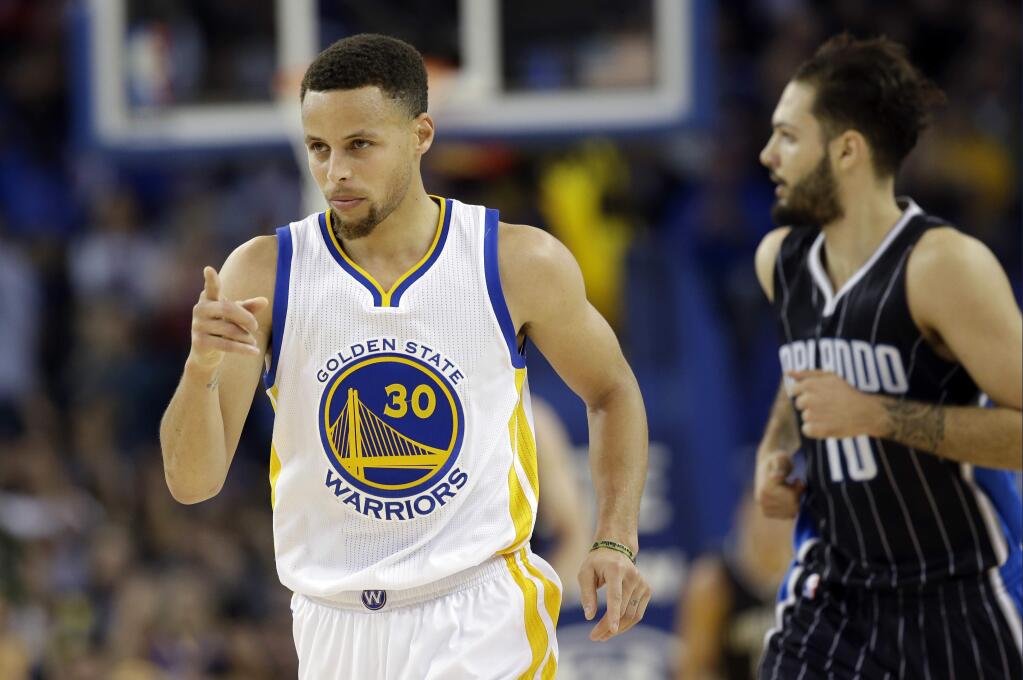 Golden State Warriors' Stephen Curry (30) gestures after scoring against the Orlando Magic during the first half of an NBA basketball game Monday, March 7, 2016, in Oakland, Calif. (AP Photo/Marcio Jose Sanchez)