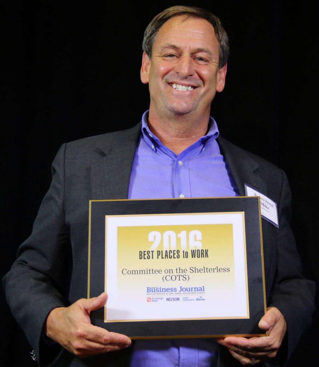 Mike Johnson of Committee on the Shelterless (COTS) accepts one of North Bay Business Journal's Best Places to Work awards at Hyatt Vineyard Creek Hotel & Spa on Sept. 29, 2016. (JEFF QUACKENBUSH / NORTH BAY BUSINESS JOURNAL)