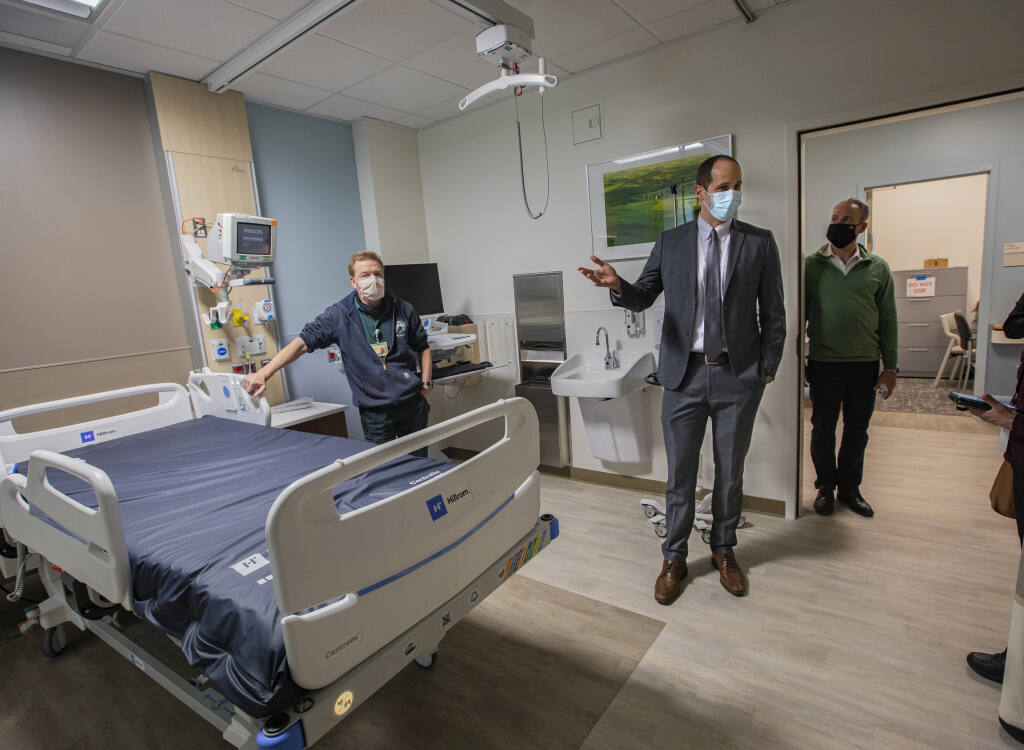 Sutter Santa Rosa CEO Dan Peterson, center, explains staff suggested features of the new patient rooms on the Horizon View Suite floor during a media tour at Sutter Santa Rosa Regional Hospital’s new patient wing on Tuesday March 29, 2022. (Chad Surmick / The Press Democrat)