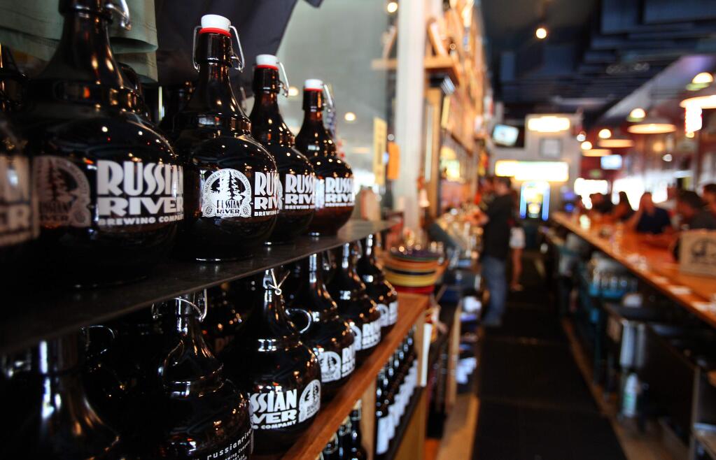 9/5/2013: E1:PC: Growlers sit on a shelf behind the bar at Russian River Brewing Company, in Santa Rosa, on Wednesday, September 4, 2013. (Christopher Chung/ The Press Democrat)