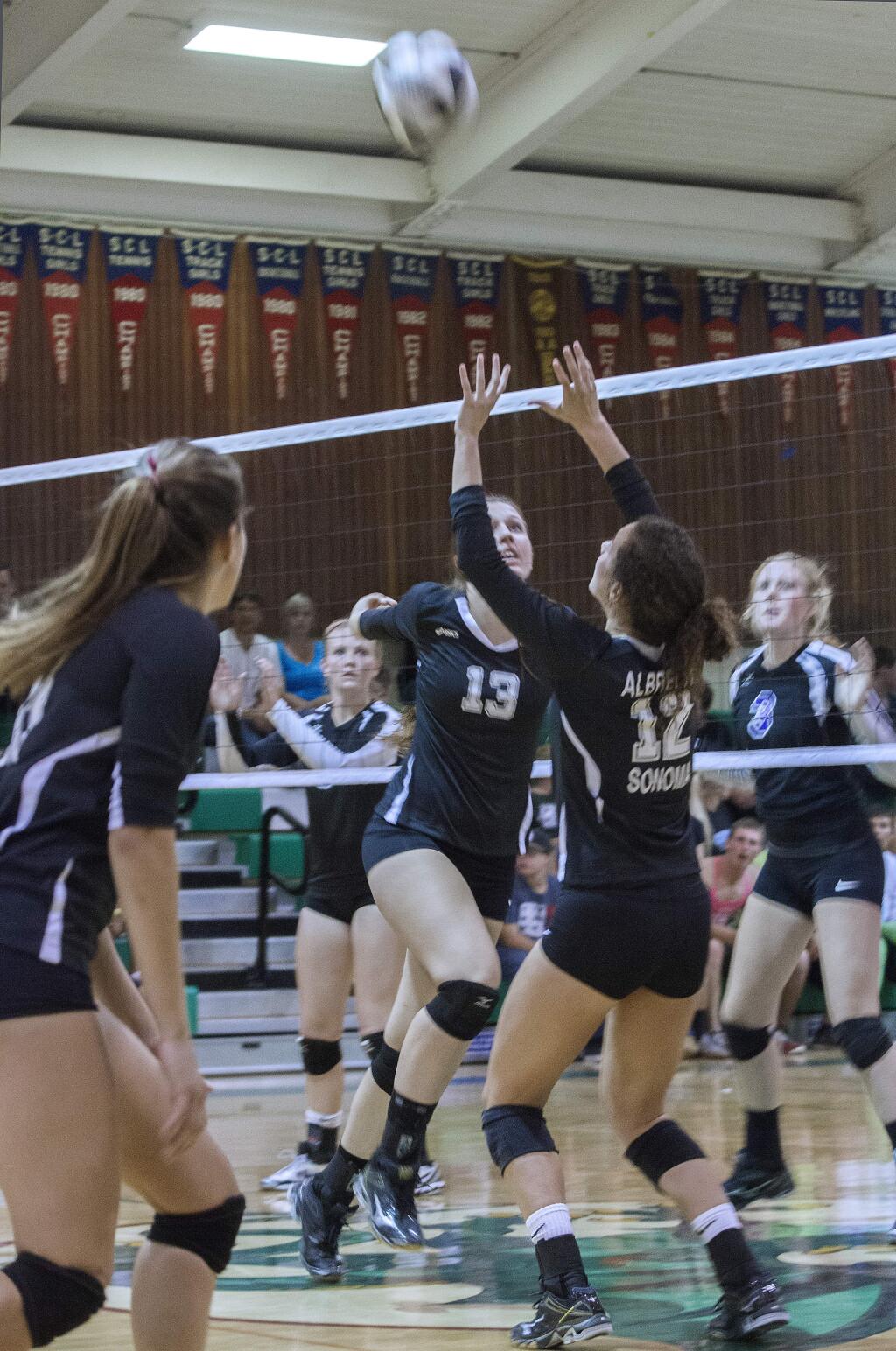 Robbi Pengelly/Index-TribuneReigning SCL player of the year Mackenzie Albrecht (No. 12) sets up teammate Ciara Smith (No. 13) for a kill during the three-time defending SCL champion Lady Dragons' league-opening victory over longtime rival Petaluma Tuesday night in Pfeiffer Gym.