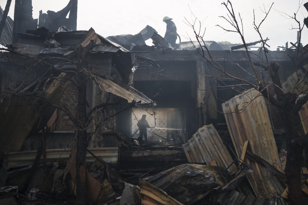 Firefighters work to extinguish a fire at a house after a Russian attack in Kharkiv, Ukraine, Monday, April 11, 2022. (AP Photo/Felipe Dana)