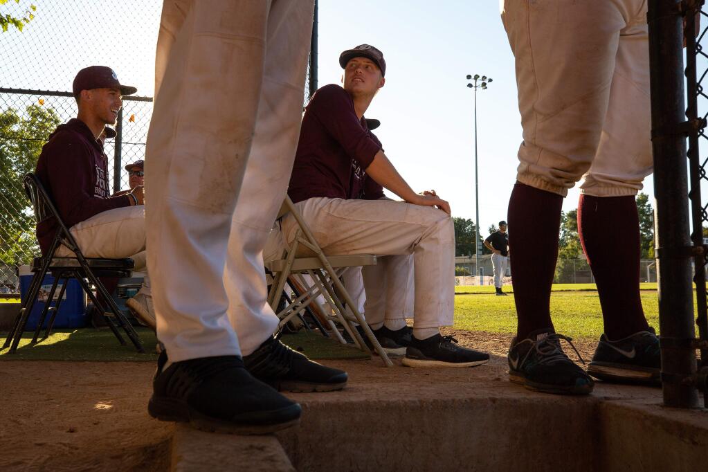 Prune Packers pitchers Trey Garlett, right, and Shamus Lyons watch the game from the dugout area during a game against the San Francisco Seals, at Healdsburg Recreation Park in Healdsburg on Wednesday, July 10, 2019. (Alvin Jornada / The Press Democrat)