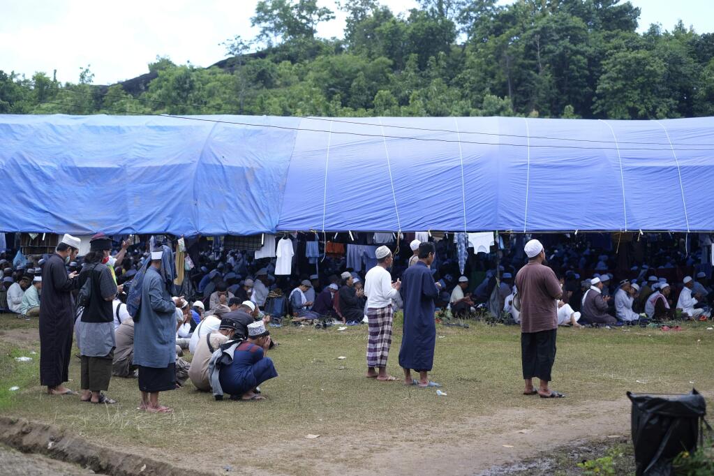 Pilgrims pray on a field where a mass congregation is supposed to be held in Gowa, South Sulawesi, Indonesia, Thursday, March 19, 2020. Indonesia halted a the congregation of thousands of Muslim pilgrims and began quarantining and checking their health Thursday to prevent the spread of the new coronavirus. The vast majority of people recover from the new coronavirus. According to the World Health Organization, most people recover in about two to six weeks, depending on the severity of the illness. (AP Photo/Syaief)