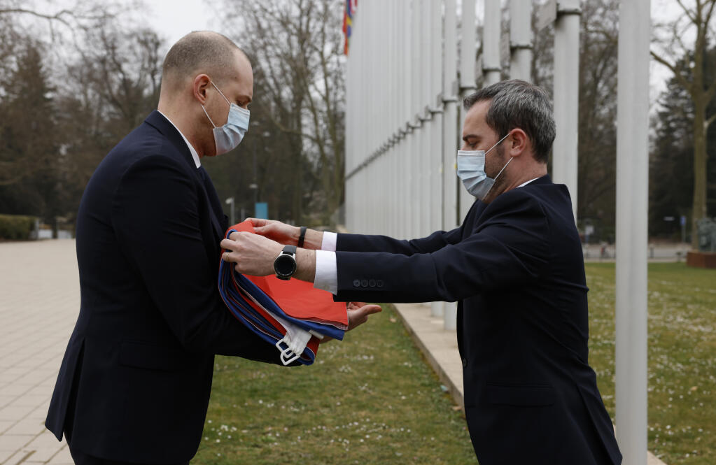 Employees of the Council of Europe fold the Russian flag after it was removed from the Council of Europe building, Wednesday, March 16, 2022 in Strasbourg. The Council of Europe expelled Russia from the continent's foremost human rights body in an unprecedented move over its invasion and war in Ukraine. The 47-nation organization's committee of ministers said in statement that "the Russian Federation ceases to be a member of the Council of Europe as from today, after 26 years of membership." (AP Photo/Jean-Francois Badias)