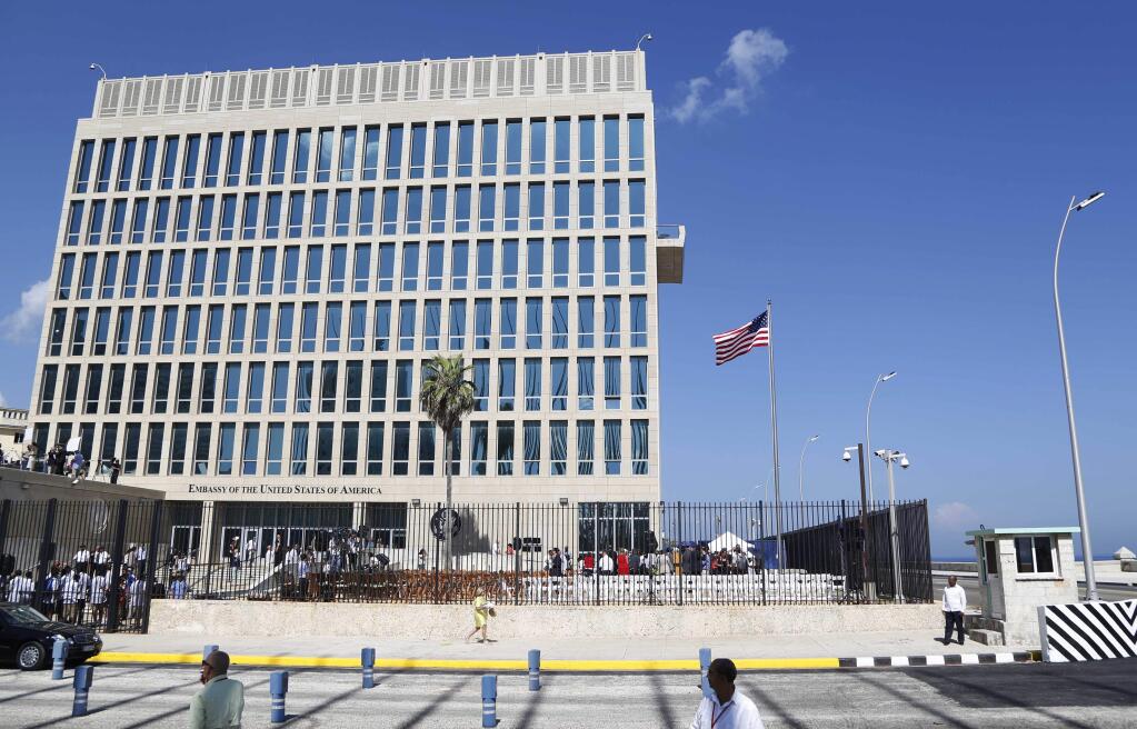 FILE - In this Aug. 14, 2015, file photo, a U.S. flag flies at the U.S. embassy in Havana, Cuba. Senior U.S. officials say the United States is pulling roughly 60 percent of its staff out of Cuba and warning American travelers not to visit due to “specific attacks” that have harmed U.S. diplomats. (AP Photo/Desmond Boylan, File)