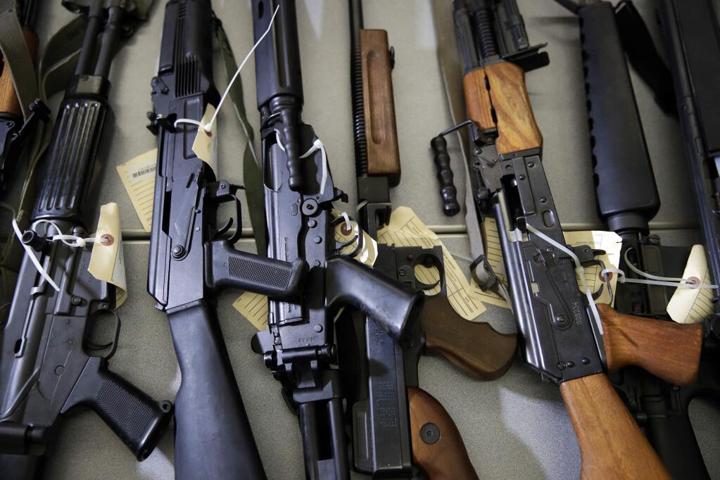 Illegally possessed firearms seized by authorities are shown at a news conference in Los Angeles Tuesday, Oct. 9, 2018. Officials say a new police task force targeting people who aren't allowed to have guns has led to the arrest of 35 people and the seizure of more than 100 firearms since June, 2018. California Attorney General Xavier Becerra touted the Los Angeles task force's work at the news conference Tuesday but acknowledged that an ever-increasing backlog of prohibited possessors remains. (AP Photo/Jae C. Hong)