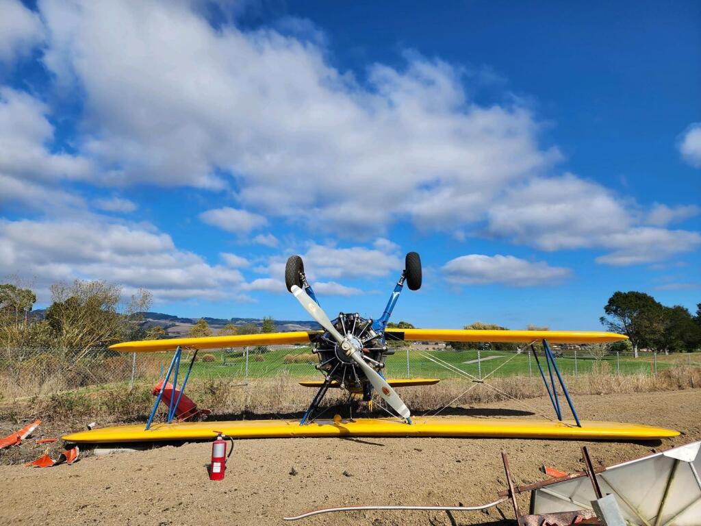 A biplane lies on its roof after it flipped over while taxiing at the Petaluma Municipal Airport on Saturday, Oct. 15, 2022. (Photo courtesy Petaluma Police Department)