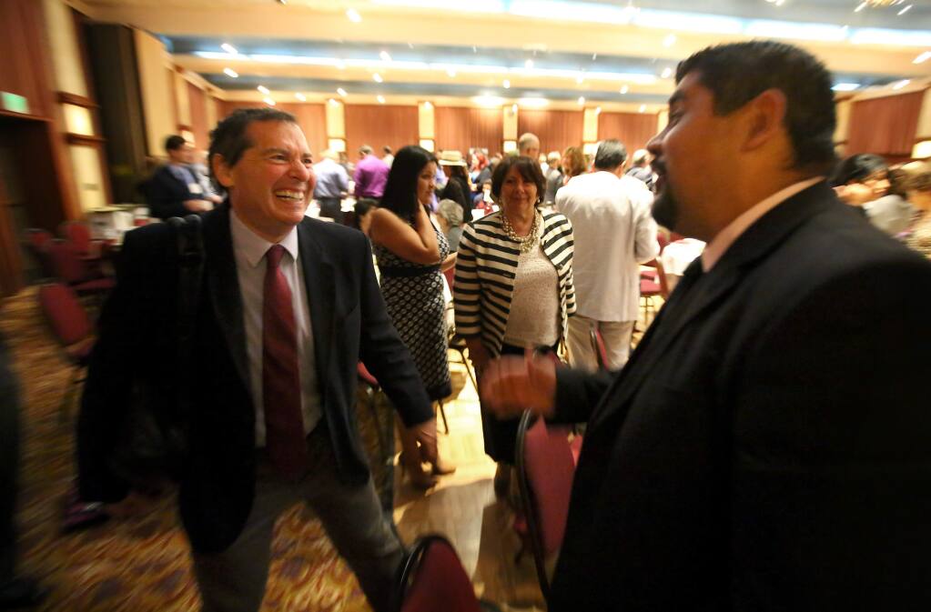 Keynote speaker Dr. David Grusky, professor of sociology at Stanford University, talks with Oscar Chavez, assistant director of human services for Sonoma County, during a break at the Los Cien State of the Latino Community event, in Santa Rosa on Thursday, October 2, 2014. (Christopher Chung/ The Press Democrat)