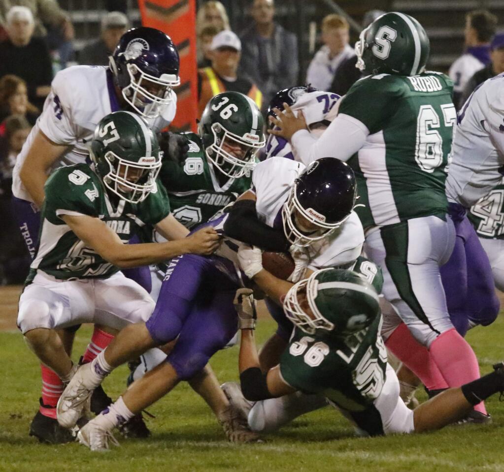 Bill Hoban/Special to the Index-TribuneDragons James Greenslade (#57), Ryan sherwood (#36), Paublo Rubio (#67) and Gavin Lehane (#56) converge on a Petaluma ball carrier during Friday night's game. The Trojans spoiled the Dragon homecoming with a 30-12 win. Sonoma finishes off its regular season Friday when they travel to Napa to face Vintage.