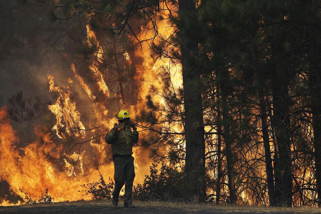 The 2013 Rim fire at Yosemite emitted 12.06 million tons of carbon dioxide, three times more than all the greenhouse gas reductions achieved that year in all other sectors in California (JAE C. HONG / Associated Press, 2013)