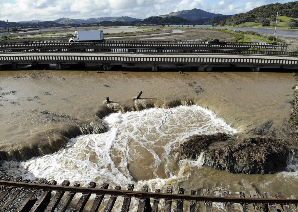 Water from recent heavy rain storms breaches a levee near Novato. The levee failure resulted in flooding that closed a portion of Highway 37. (TERRY CHEA / Associated Press)