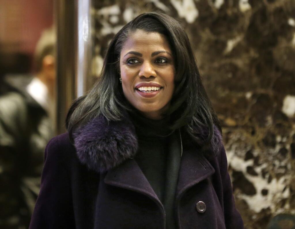 FILE - In this Dec. 13, 2016 file photo, Omarosa Manigault smiles at reporters as she walks through the lobby of Trump Tower in New York. The White House says Omarosa Manigault Newman, one of President Donald Trump's most prominent African-American supporters, plans to leave the administration next month. (AP Photo/Seth Wenig)