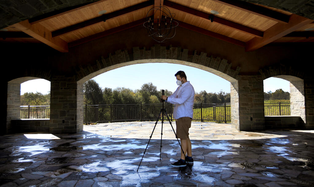Japhy Altenhein, at Bricoleur Vineyards, prepares to use a small camera to make a 360-degree picture that will be used for a virtual tour of the winery, Wednesday, Oct. 21, 2020, in Windsor. (Kent Porter / The Press Democrat) 2020