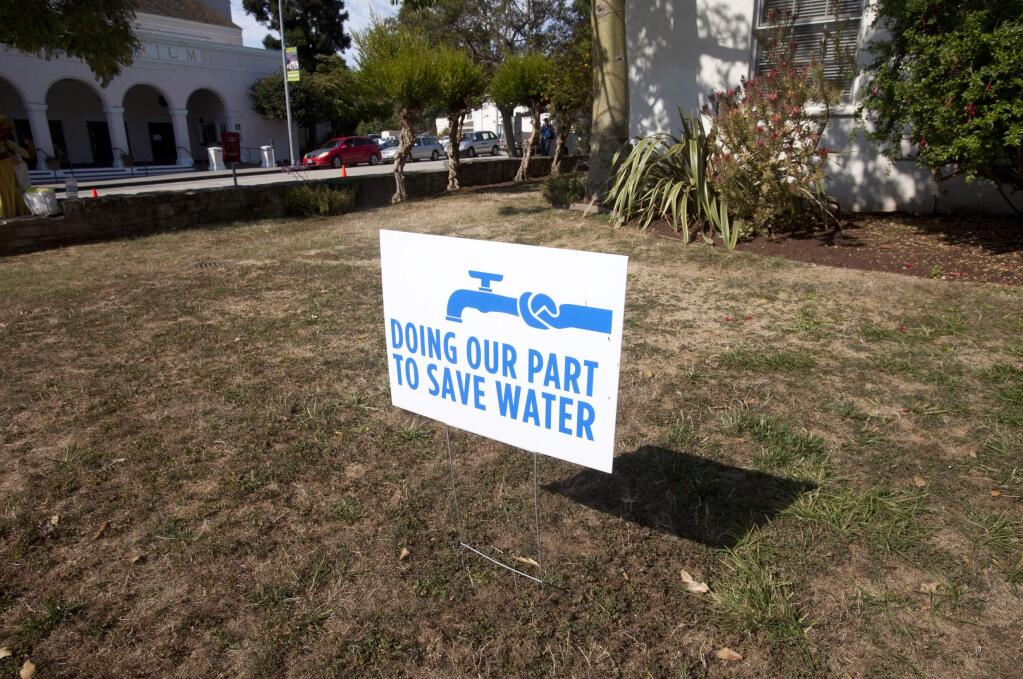 A water conservation sign is shown displayed outside of City Hall in Santa Cruz, Tuesday, July 29, 2014. Unlike most cities that have either groundwater, a connection to state water canals, or vast reservoirs, Santa Cruz is among those worst hit by the drought because it relies almost exclusively on storm runoff into a river, some creeks and an aging reservoir. (AP Photo/Bay Area News Group, Patrick Tehan)