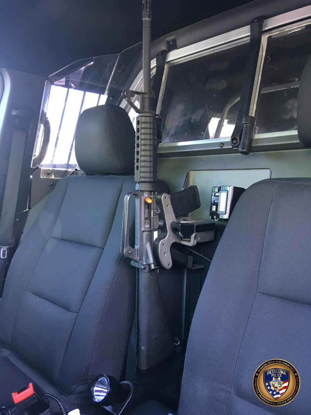 A Petaluma Police Department Colt M16-A1 rifle is locked in a rifle rack inside a police car. PETALUMA POLICE DEPARTMENT