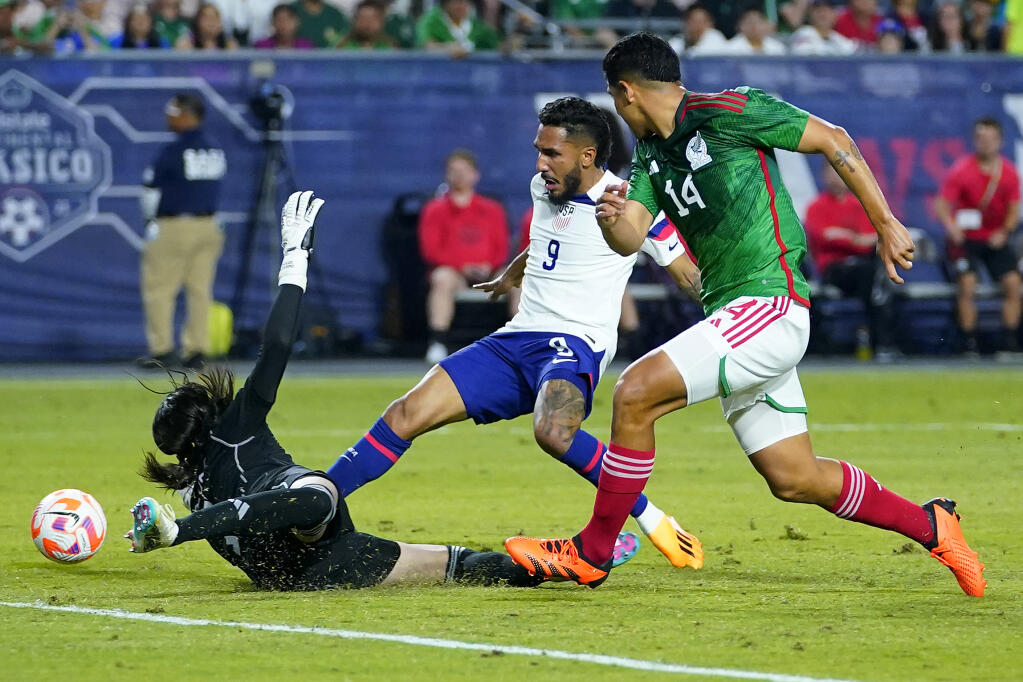 The United States’ Jesus Ferreira (9) scores a goal as Mexico’s goal keeper Carlos Acevedo and Victor Guzman (14) defend during the second half of the inaugural Continental Clasico exhibition, Wednesday, April 19, 2023, in Glendale, Arizona. (Matt York / ASSOCIATED PRESS)