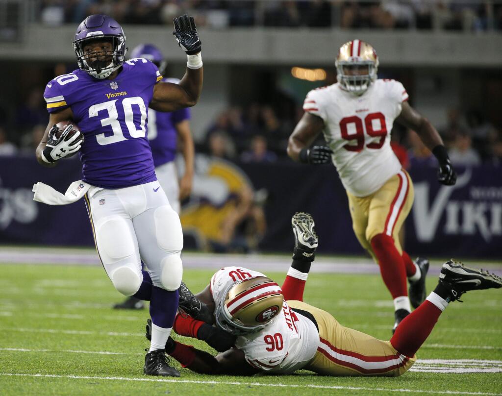 Minnesota Vikings running back C.J. Ham (30) tries to break a tackle by San Francisco 49ers defensive tackle Earl Mitchell (90) during the first half of a preseason game Sunday, Aug. 27, 2017, in Minneapolis. (AP Photo/Bruce Kluckhohn)