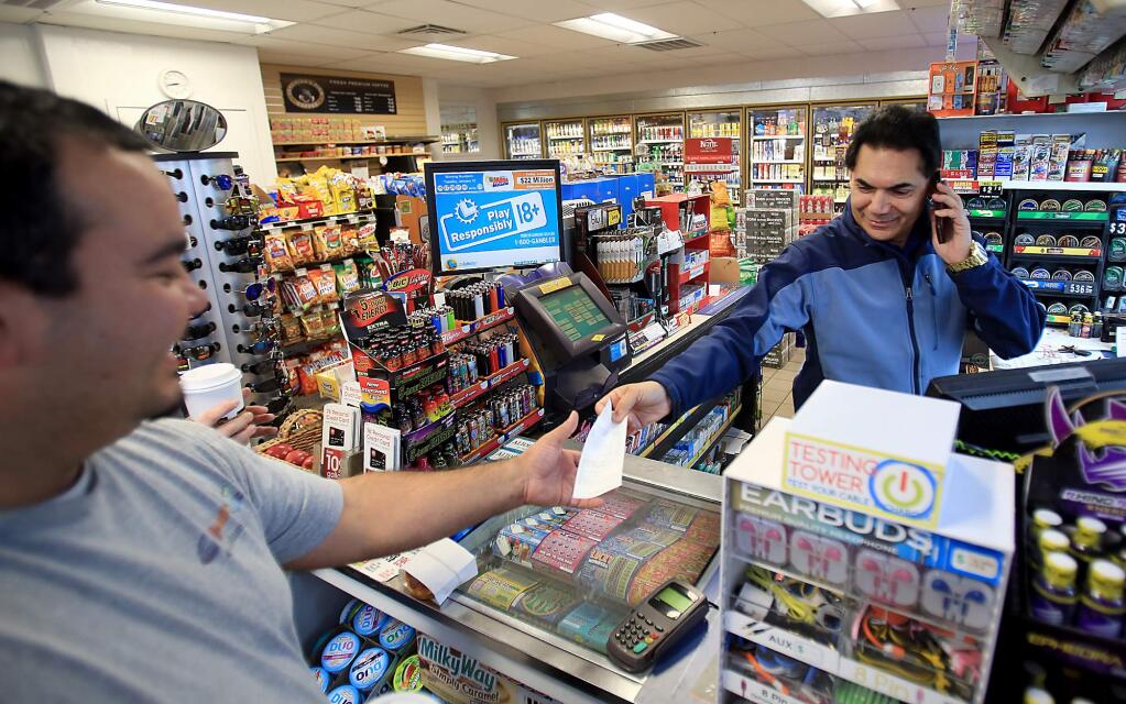 Larkfield Union 76 manager Kuldeep Singh, right, sold a ticket worth $638,146 at the station Wednesday, Jan. 13, 2016. Thursday, Singh was all smiles. (KENT PORTER/ PD)