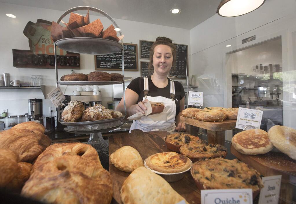 Melissa Cameron prepares to plate one of the many goodies available to eat in our take out at the former Crisp Bakeshop, soon to be named Honey & the Moon on West Napa Street (Photo by Robbi Pengelly/Index-Tribune)