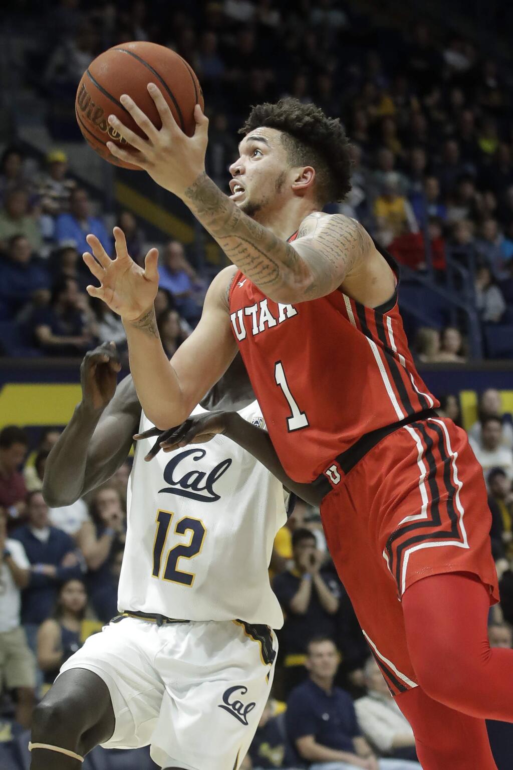 Utah forward Timmy Allen (1) shoots against Cal forward Kuany Kuany (12) during the first half in Berkeley, Saturday, Feb. 29, 2020. (AP Photo/Jeff Chiu)