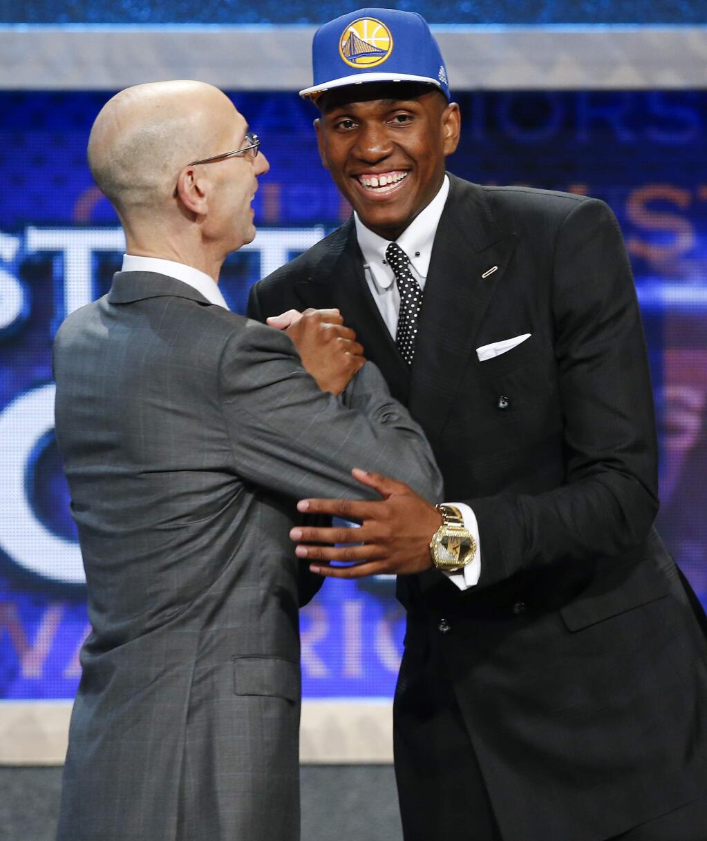 Kevon Looney, right, greets NBA Commissioner Adam Silver after being selected 30th overall by the Golden State Warriors during the NBA draft, Thursday, June 25, 2015, in New York. (AP Photo/Kathy Willens)