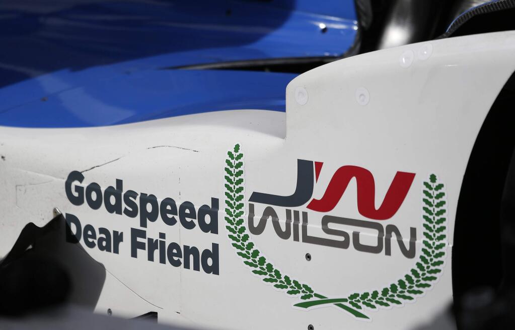 A tribute to Justin Wilson is displayed on the side of the No. 19 car driven by Tristan Vautier, of France, during practice for the IndyCar auto race Friday, Aug. 28, 2015, in Sonoma, Calif. Wilson, of England, died Monday from injuries sustained at Pocono Raceway on Sunday. (AP Photo/Eric Risberg)