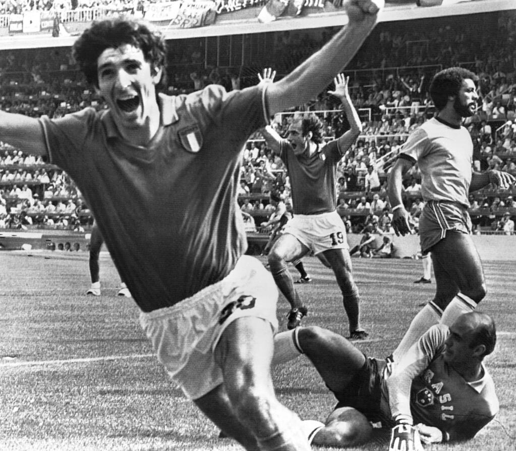 FILE - In this July 5, 1982 file photo, Italy's Paolo Rossi, left, celebrates, after scoring the second goal for his team during their World Cup second round soccer match against Brazil, in Barcelona, Spain. Rossi died of Cancer, Dec. 10, 2020. He was 64. (AP Photo/File)