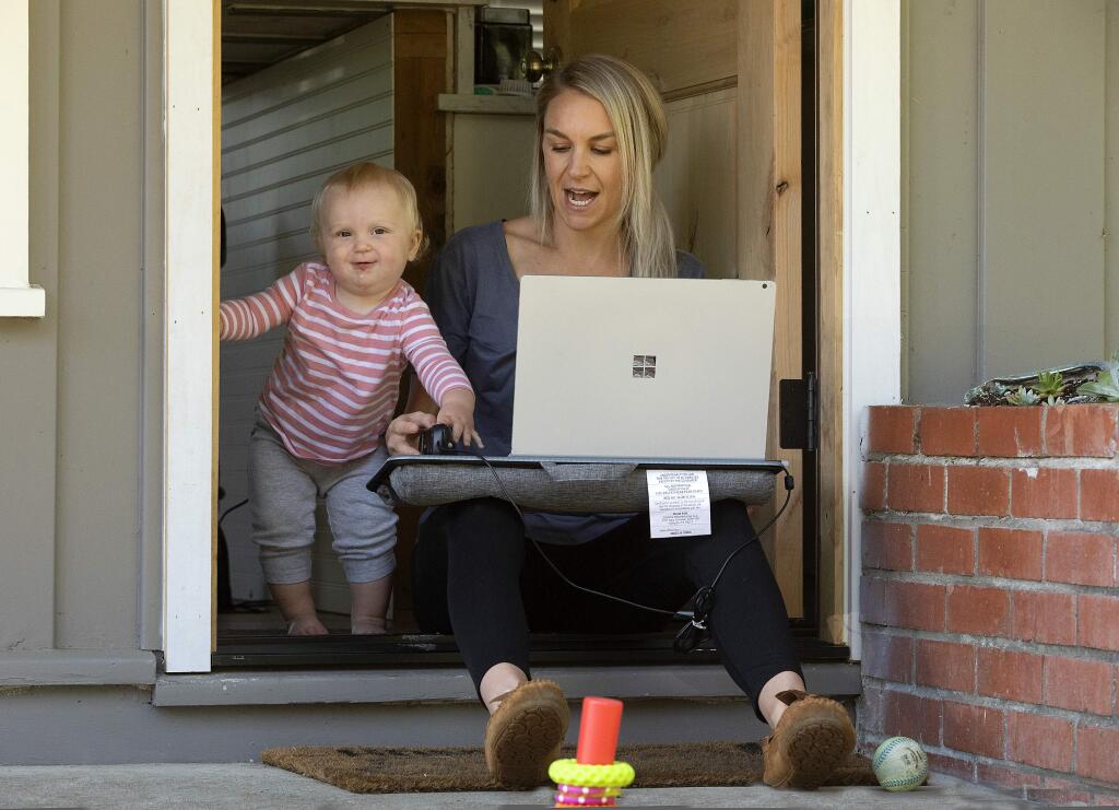 Sales professional Erin Newton balances the needs of her daughter Brooklyn, 14 months, with working from home in Penngrove. (photo by John Burgess/The Press Democrat).