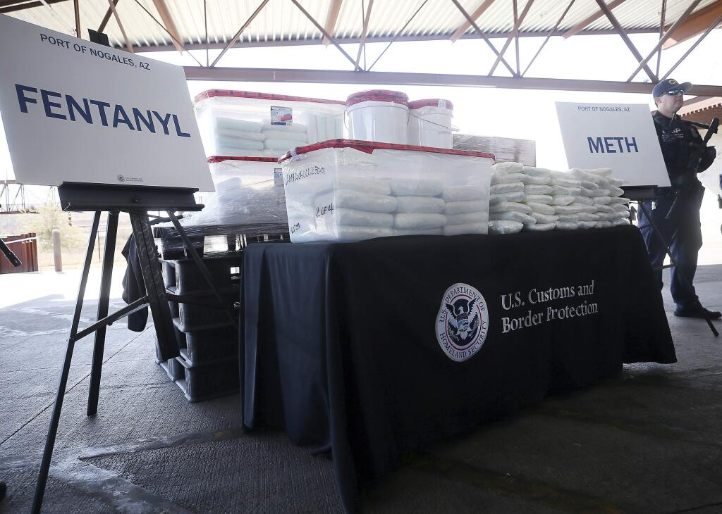 A display of the fentanyl and meth that was seized by Customs and Border Protection officers over the weekend at the Nogales Port of Entry is shown during a press conference on Thursday, Jan. 31, 2019, in Nogales, Ariz. U.S. Customs and Border Protection officials announced Thursday their biggest fentanyl bust ever, saying they captured nearly 254 pounds (114 kilograms) of the deadly synthetic opioid from a secret compartment inside a load of Mexican produce heading into Arizona. (Mamta Popat/Arizona Daily Star via AP)