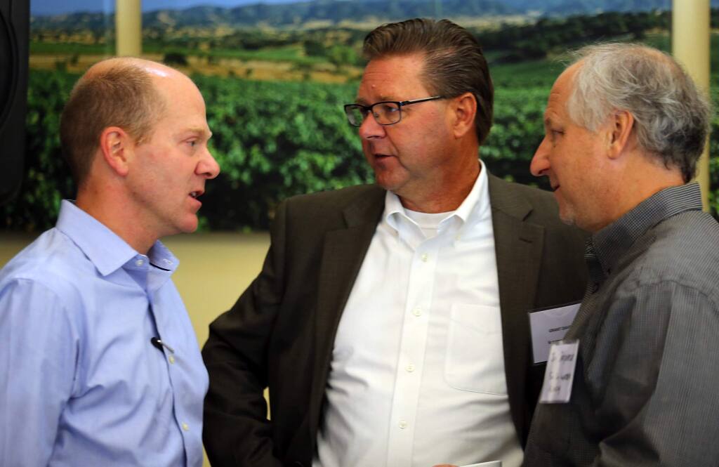 Director of the California Department of Fish and Wildlife Charlton “Chuck” Bonham, left, talks with Grant Davis, center, and Jay Jasperse from the Sonoma County Water Agency after a press conference at Kendall=Jackson Wine Estates in Santa Rosa on friday.(JOHN BURGESS / The Press Democrat)
