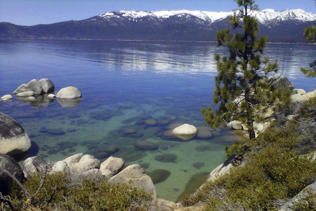 FILE - This April 12, 2012 file photo shows Lake Tahoe seen from Incline Village, Nev. An annual report on Lake Tahoe said the United States' largest alpine lake is still warming at 14 times the historic average. The finding is in the yearly report released Thursday, July 27, 2017, by the University of California at Davis on the state of Lake Tahoe, which straddles the California and Nevada borders. (AP Photo/Scott Sonner, File)