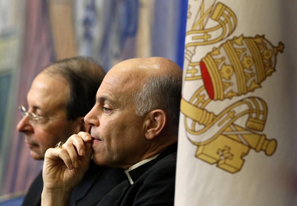 FILE - In this Nov. 12, 2012 file photo, Archbishop Salvatore Cordileone, of San Francisco, center, and Archbishop William Lori, of Baltimore, listen to a speaker during the United States Conference of Catholic Bishops' annual fall meeting in Baltimore. Local Catholics have gone public with their complaints about the San Francisco archbishop. On Thursday, April 16, 2015, an advertisement in the San Francisco Chronicle shows more than 100 Catholics have signed a full-page newspaper advertisement asking Pope Francis to remove Cordileone. (AP Photo/Patrick Semansky, File)